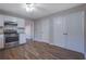 Kitchen features white cabinets, stainless steel appliances, and hardwood floors at 6110 Dorsett St, Douglasville, GA 30134