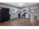 Kitchen boasts white cabinets, stainless steel appliances, and hardwood floors at 6110 Dorsett St, Douglasville, GA 30134