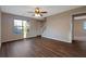 Bright living room with hardwood floors, large windows, and a ceiling fan at 6110 Dorsett St, Douglasville, GA 30134
