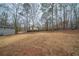 Expansive backyard with mature trees and houses in background, providing plenty of privacy at 6520 Chickasaw Dr, Douglasville, GA 30135