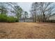 Large backyard featuring mature trees and foliage with house in background, providing shade and privacy at 6520 Chickasaw Dr, Douglasville, GA 30135