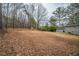 Large backyard featuring mature trees and foliage with house in background, providing shade and privacy at 6520 Chickasaw Dr, Douglasville, GA 30135