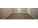 Spacious basement featuring carpeting, neutral walls, and a door at 6520 Chickasaw Dr, Douglasville, GA 30135