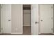 Bedroom with neutral walls, carpet, and standard closet doors on either side at 6520 Chickasaw Dr, Douglasville, GA 30135