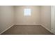 Bedroom with window, neutral walls, carpet, and white trim at 6520 Chickasaw Dr, Douglasville, GA 30135