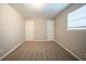 Bedroom with neutral walls, carpet, window, and standard closet doors at 6520 Chickasaw Dr, Douglasville, GA 30135