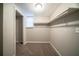Well-lit closet with carpeted floors and a built-in shelving system for optimal storage at 6520 Chickasaw Dr, Douglasville, GA 30135