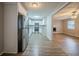 Updated kitchen showcasing stainless steel appliances, white cabinets, and wood-look floors at 6520 Chickasaw Dr, Douglasville, GA 30135