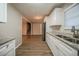 Stylish kitchen features stainless steel appliances, wood-look floors, and granite countertops at 6520 Chickasaw Dr, Douglasville, GA 30135