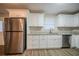 Modern kitchen featuring stainless steel appliances, white cabinets, and granite countertops at 6520 Chickasaw Dr, Douglasville, GA 30135