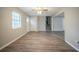 Spacious living room boasts wood-look floors, neutral paint, and a ceiling fan at 6520 Chickasaw Dr, Douglasville, GA 30135