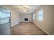 Inviting living room features a brick fireplace, wood-look floors and ample natural light at 6520 Chickasaw Dr, Douglasville, GA 30135