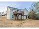 The backyard of this home features a wood deck and a well maintained lawn at 100 Arthurs Ln, Covington, GA 30016