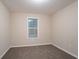 This bedroom has carpet floors, neutral walls, and a window at 100 Arthurs Ln, Covington, GA 30016