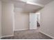 Bedroom with a door leading to the staircase, carpet, and neutral walls at 100 Arthurs Ln, Covington, GA 30016