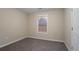 Bedroom with neutral walls, carpet, and a window providing natural light at 100 Arthurs Ln, Covington, GA 30016