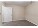 This bedroom features neutral walls, carpeted floors, and a white door at 100 Arthurs Ln, Covington, GA 30016