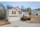 Split-level home with light siding, black shutters, a garage and a large yard is on display at 100 Arthurs Ln, Covington, GA 30016