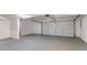 This garage features a large white door and painted floor at 100 Arthurs Ln, Covington, GA 30016