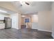 Living room adjacent to kitchen featuring granite counters, wood floors, and neutral walls at 100 Arthurs Ln, Covington, GA 30016