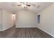 The living room has wood floors, a ceiling fan, neutral walls and natural light from the window at 100 Arthurs Ln, Covington, GA 30016