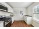 Updated kitchen featuring white cabinets and granite countertops at 1770 Lee St, Decatur, GA 30035