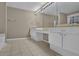 Double vanity bathroom with neutral tile flooring at 2105 Cornerstone Sw Ln, Marietta, GA 30064