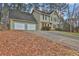 Green two-story house with a three-car garage and a sloping driveway at 2105 Cornerstone Sw Ln, Marietta, GA 30064
