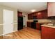 Kitchen with dark wood cabinets and black appliances at 2105 Cornerstone Sw Ln, Marietta, GA 30064