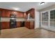 Kitchen with dark wood cabinets, black appliances, and laminate flooring at 2105 Cornerstone Sw Ln, Marietta, GA 30064