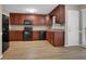 Kitchen boasts dark wood cabinets and black appliances at 2105 Cornerstone Sw Ln, Marietta, GA 30064