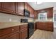 Bright kitchen featuring wood cabinets, black appliances, and light countertops at 2105 Cornerstone Sw Ln, Marietta, GA 30064