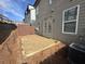 Backyard view featuring a small patio and the exterior of the two-story home at 2113 Garden Pl, Atlanta, GA 30316