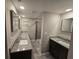 Bathroom with double granite vanity sinks and a glass-enclosed shower at 2113 Garden Pl, Atlanta, GA 30316