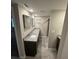 Bathroom featuring double sink vanity with granite countertops and a walk-in shower at 2113 Garden Pl, Atlanta, GA 30316