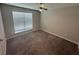 Bedroom with tan walls, ceiling fan, carpet, and a window with blinds at 2113 Garden Pl, Atlanta, GA 30316