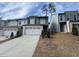 New construction townhomes with light brick, light grey paint, and two car garages at 2113 Garden Pl, Atlanta, GA 30316