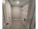 This laundry room features patterned tile flooring and a wire rack shelf for storage at 2113 Garden Pl, Atlanta, GA 30316