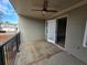 This covered patio has a ceiling fan and sliding door, and a dark metal safety rail at 2113 Garden Pl, Atlanta, GA 30316