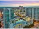 Aerial view of a modern city building complex with a rooftop pool at dusk at 250 Pharr Ne Rd # 413, Atlanta, GA 30305