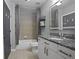 Bathroom features granite countertop, shower/tub combo, and tiled floors at 250 Pharr Ne Rd # 413, Atlanta, GA 30305