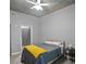 Bedroom with ceiling fan, gray bedding, and access to another room at 250 Pharr Ne Rd # 413, Atlanta, GA 30305