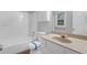 Clean bathroom with a tub, shower, and vanity at 280 Belmont Farms Dr, Ellenwood, GA 30294