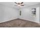 Bedroom with ceiling fan, carpet, and two windows at 280 Belmont Farms Dr, Ellenwood, GA 30294