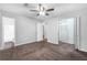 Bedroom with ceiling fan, carpet, and bathroom access at 280 Belmont Farms Dr, Ellenwood, GA 30294