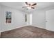 Bedroom with ceiling fan, carpet, and two windows at 280 Belmont Farms Dr, Ellenwood, GA 30294