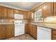 View of kitchen with wood cabinets, tile backsplash and flooring at 280 Belmont Farms Dr, Ellenwood, GA 30294