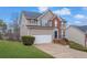 Two-story house with brick and siding exterior, attached garage, and landscaping at 415 Gresham Dr, Stockbridge, GA 30281