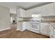 Kitchen with white cabinets, tile floor and gas range at 415 Gresham Dr, Stockbridge, GA 30281