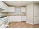 White kitchen with stainless steel appliances and tile floor at 415 Gresham Dr, Stockbridge, GA 30281